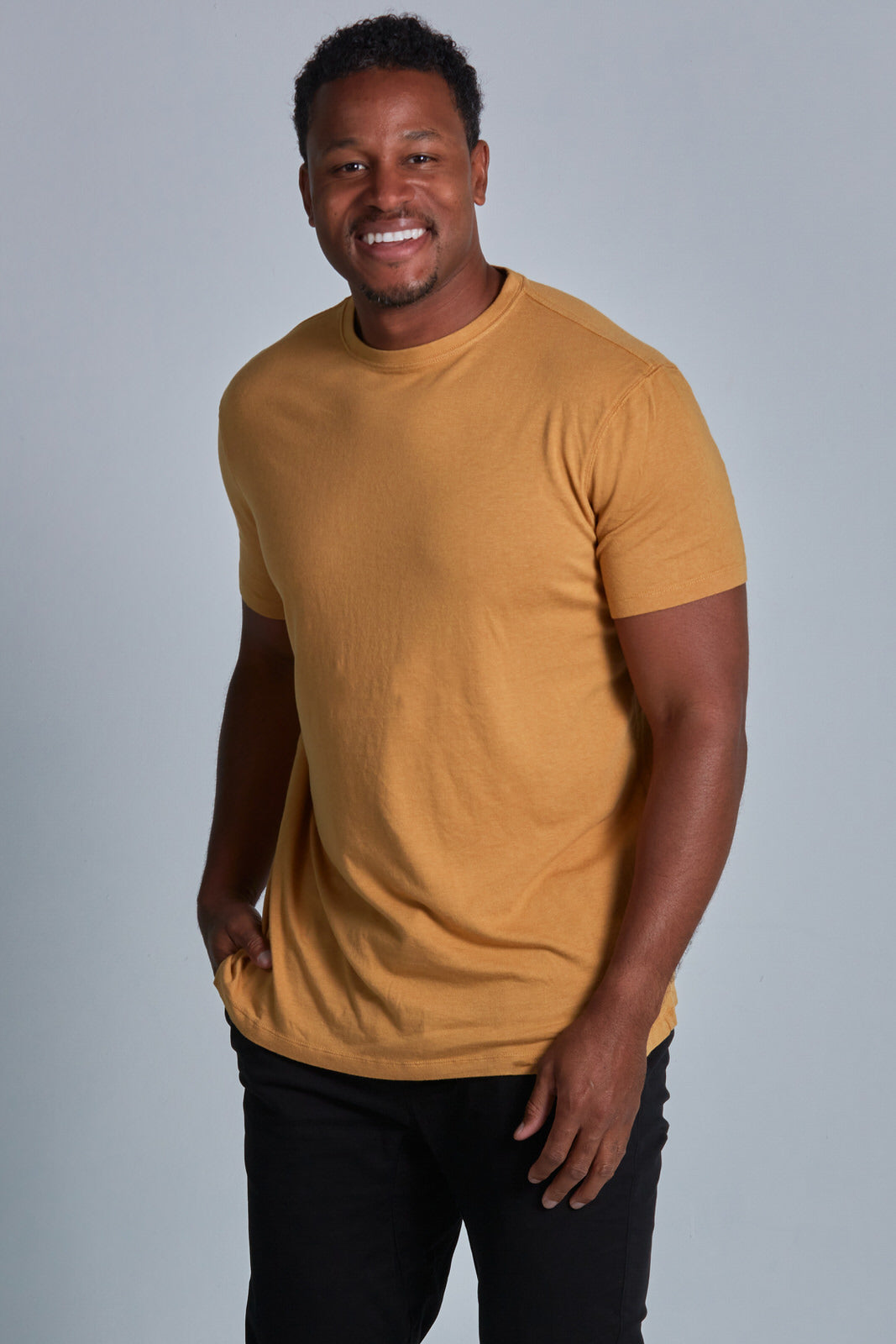 ONNO bamboo t-shirt in Mustard Unpatched, Golden is 6'0" and wearing size L.