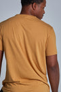 ONNO bamboo t-shirt in Mustard Unpatched, Golden is 6'0" and wearing size L.