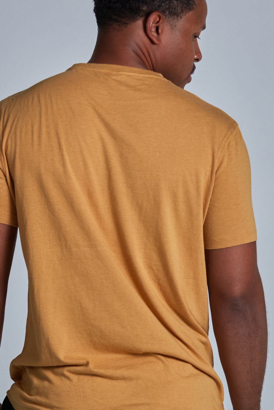 ONNO bamboo t-shirt in Mustard Unpatched, Golden is 6'0" and wearing size L.