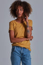 ONNO bamboo t-shirt in Mustard, Sage is 5'7" and wearing size XS.
