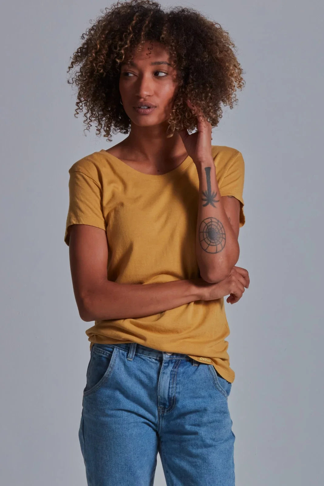 ONNO bamboo t-shirt in Mustard, Sage is 5'7" and wearing size XS.