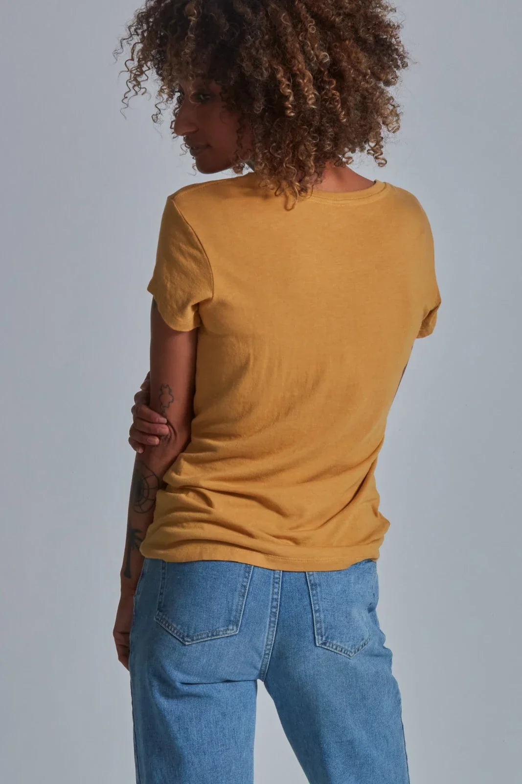 ONNO bamboo t-shirt in Mustard, Sage is 5'7" and wearing size XS.